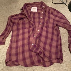Worn flannel button up shirt